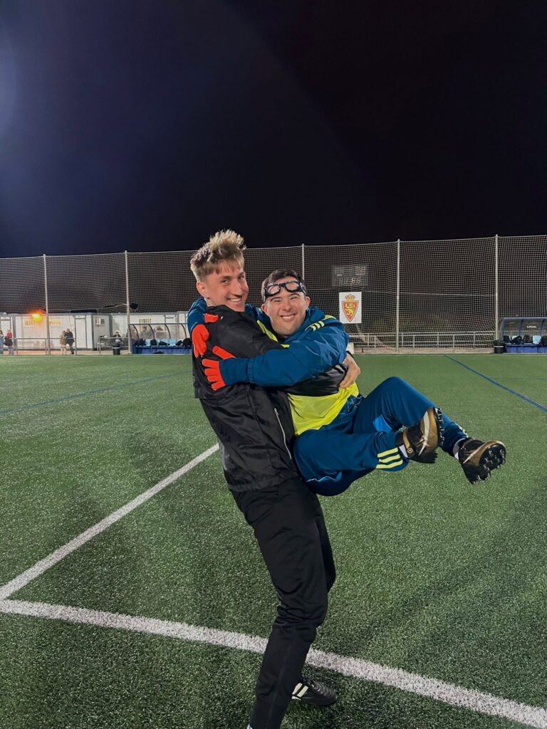 A joyful moment between a Megamocni coach and a Real Zaragoza Genuine player